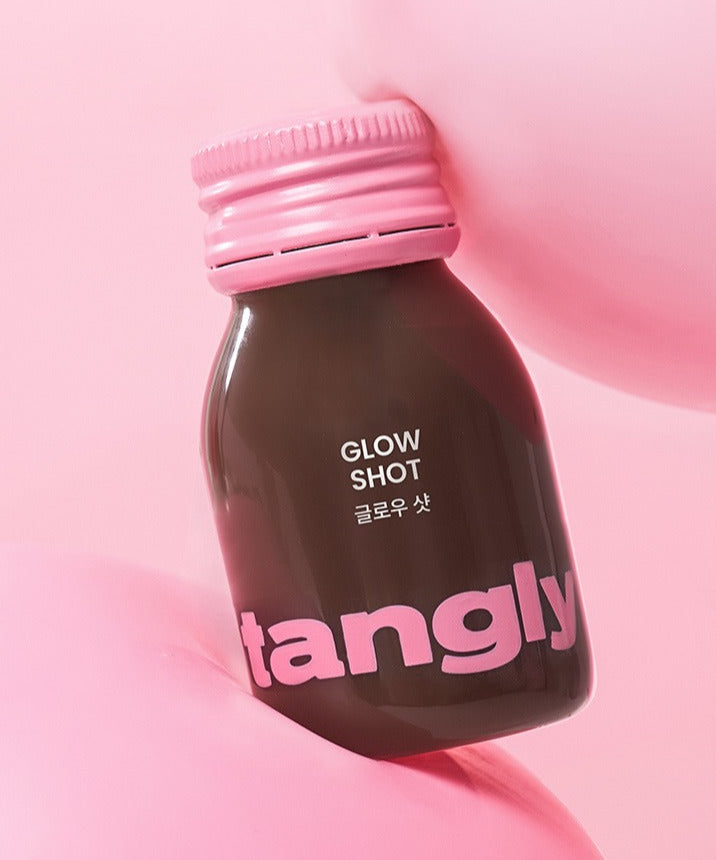 NOTHING BETTER Tangly Glow Shot 7 Bottles on pink background, highlighting the bottle design and vibrant colors.