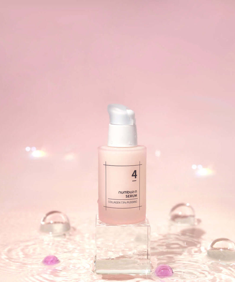 NUMBUZIN No.4 Collagen 73% Pudding Serum bottle on a pink background with droplets.