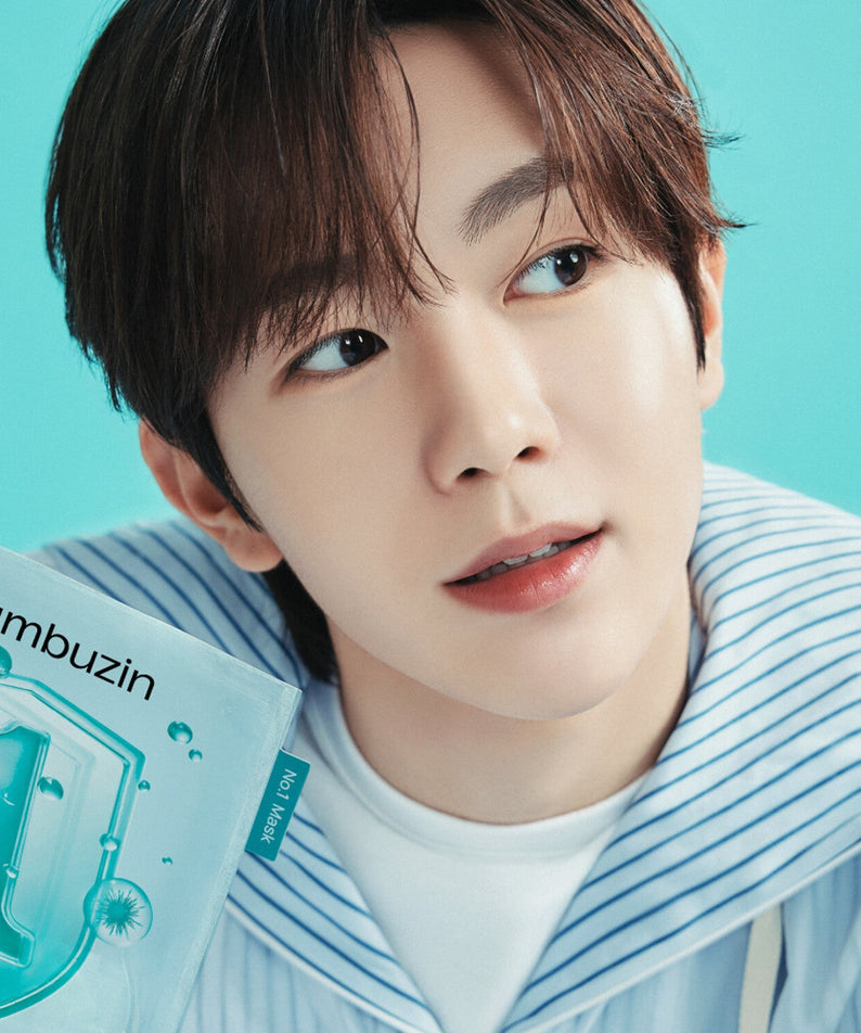 Person holding a box of NUMBUZIN No.1 Hyaluronic Panthenic Acid Clear Soothing Gauze Pack 10 sheets with a bright blue background.