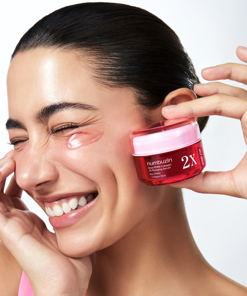 Woman using NUMBUZIN No.2 Rose PDRN Collagen 2X Plumping Serum 30ml near her eye for youthful skin.