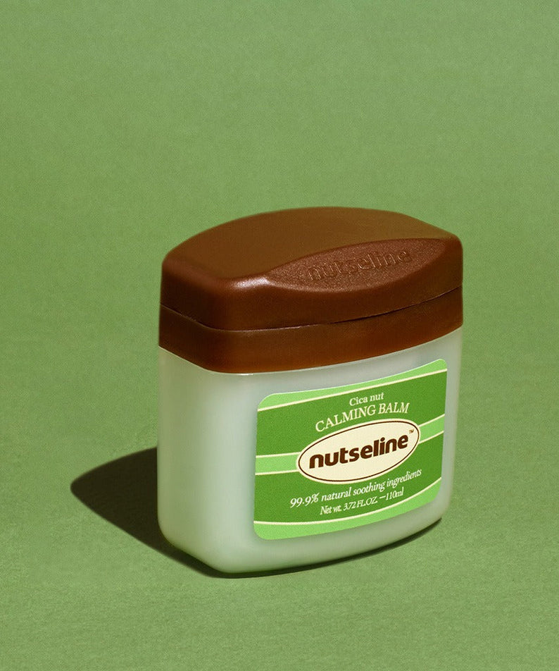 NUTSELINE Cica Nut Calming Balm Season 2 50ml jar on green background