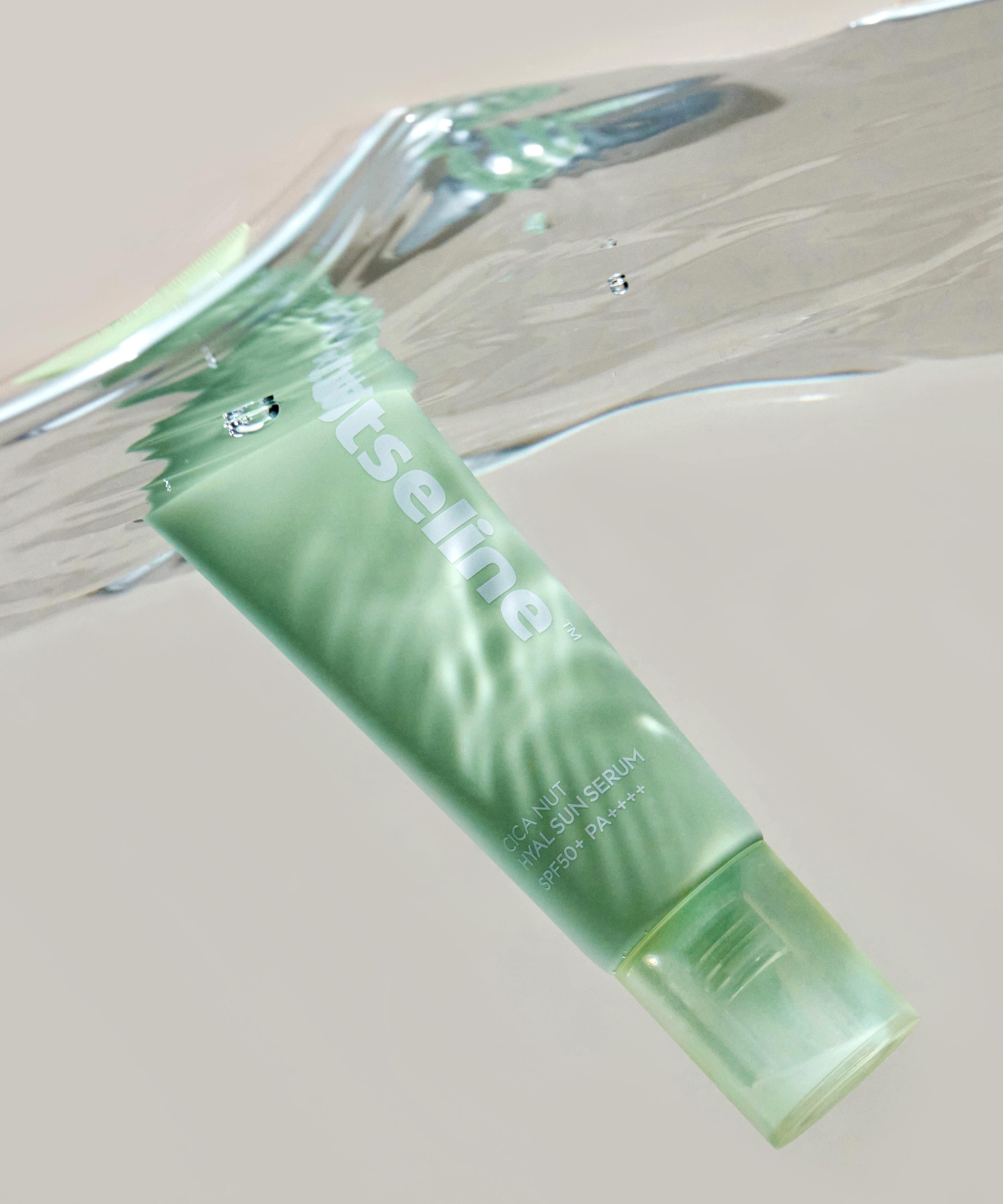 NUTSELINE Cica Nut Hyal Sun Serum 50ml submerged in water, showcasing the product's waterproof properties.