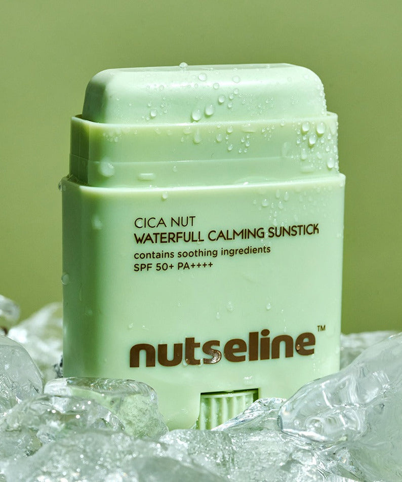 NUTSELINE Cica Nut Waterful Calming Sun Stick 20g resting on ice, showcasing its soothing ingredients and SPF 50+ protection.