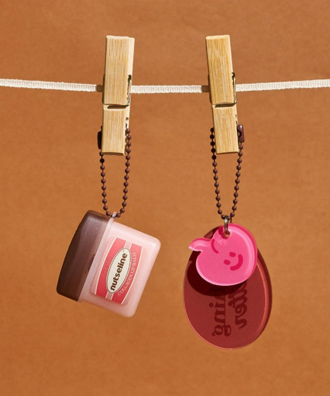 NUTSELINE Super Nut Collagen Keyring Lip Balm 11ml hanging on line with keyring attached