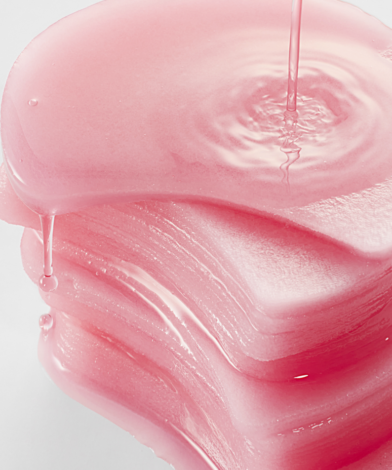 Stack of pink ANUA Niacinamide 5 TXA Brightening Pad 60 Pads with liquid pour to enhance skin brightening effect.