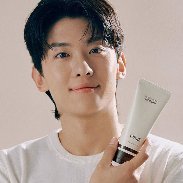 Gentleman Korea model holding OBGE Multi-texture curl cream 150ml tube for men’s styling and Korean grooming