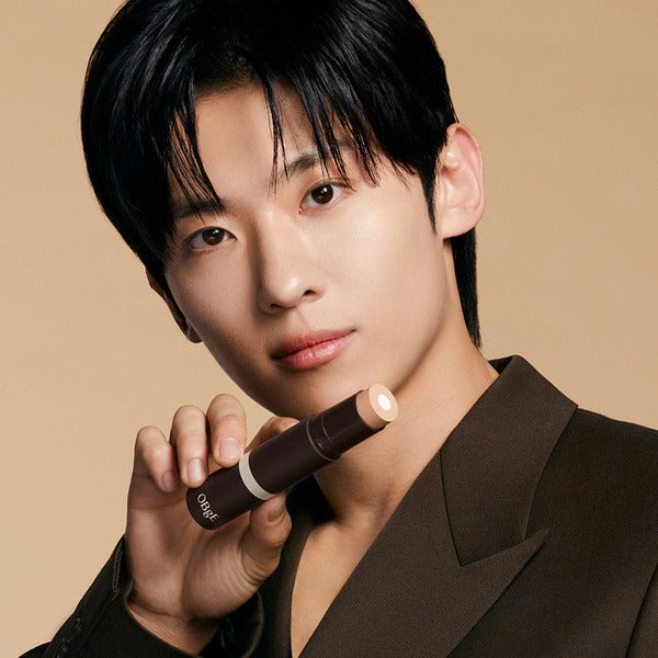 OBGE Natural Cover Foundation held by a Korean male model for Gentleman Korea, natural finish men's stick foundation showcasing product shade
