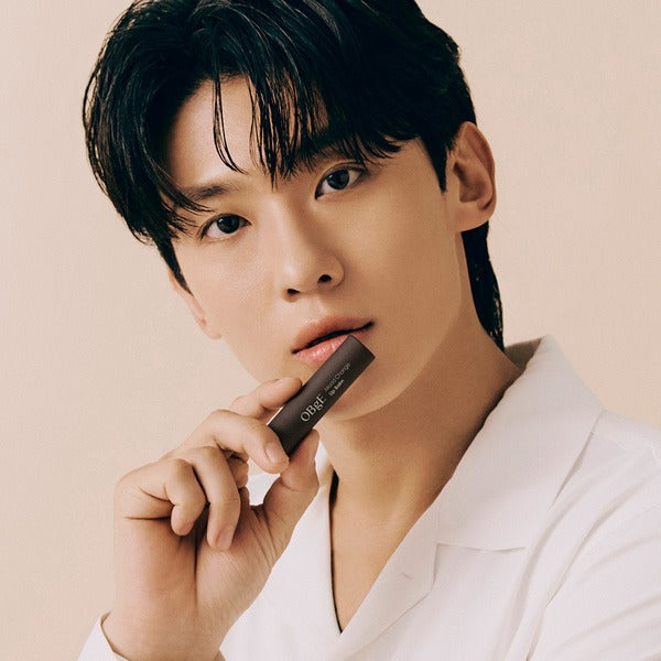 OBGE Mood Change Lip Balm 2 types held by male model in white shirt, Gentleman Korea skincare for men, close-up cosmetic product display