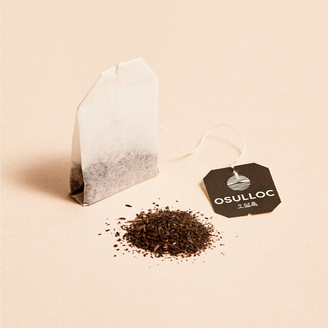 OSULLOC Jeju Volcanic Oolong Tea 20 P teabag with loose tea and branded tag on beige background