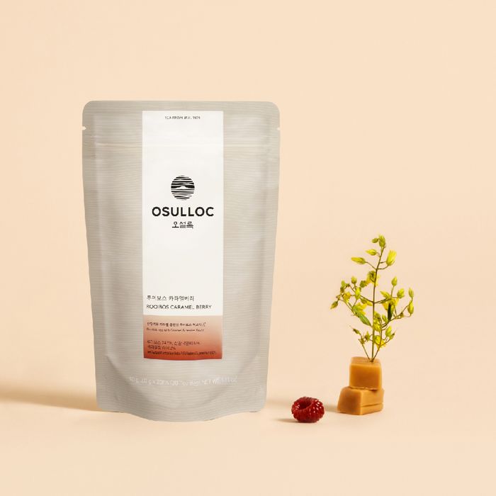 OSULLOC Rooibos Caramel Berry Tea 20p packaging with caramel pieces and berries on beige background