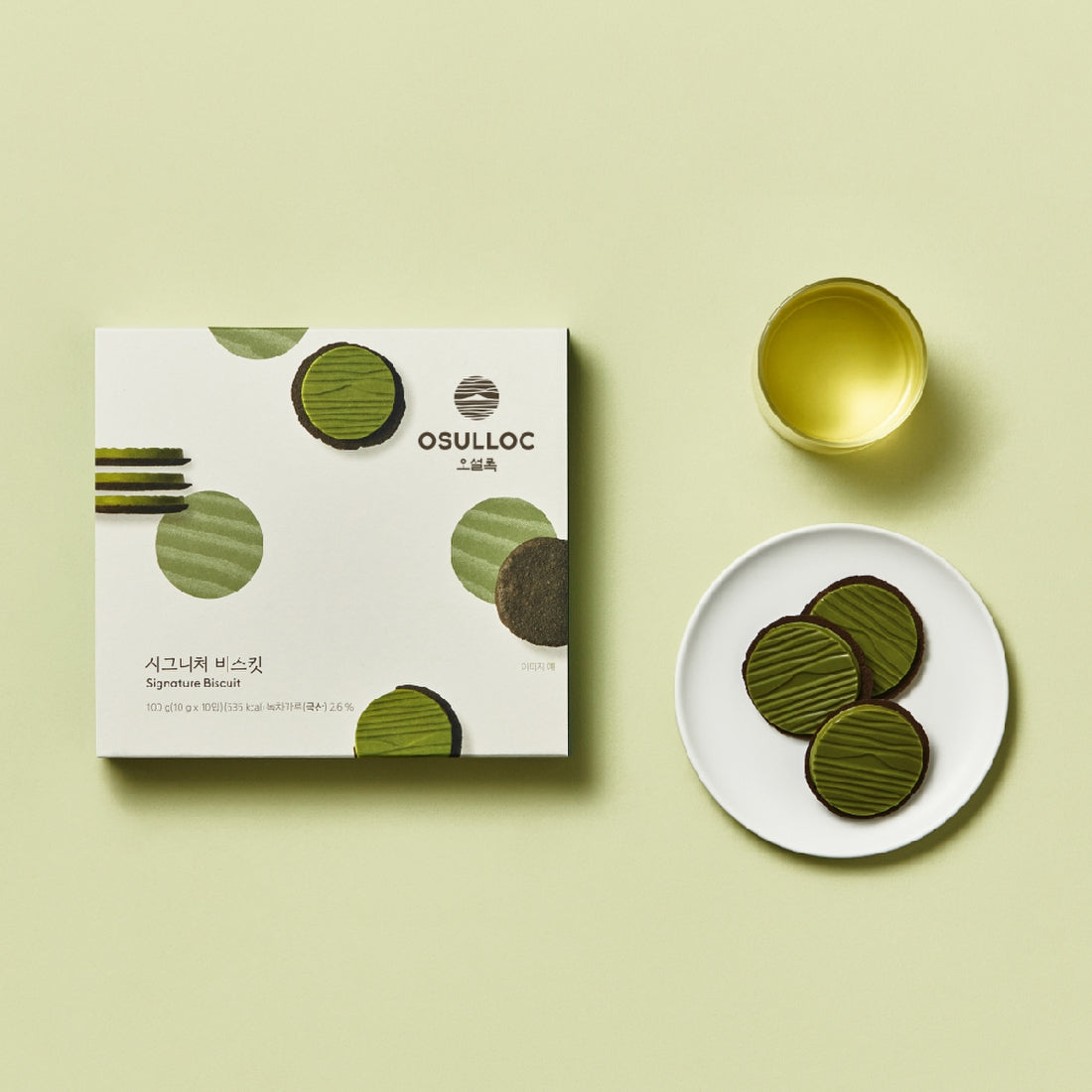 OSULLOC Signature Biscuits 10 P box with green tea and plate of biscuits on light green background