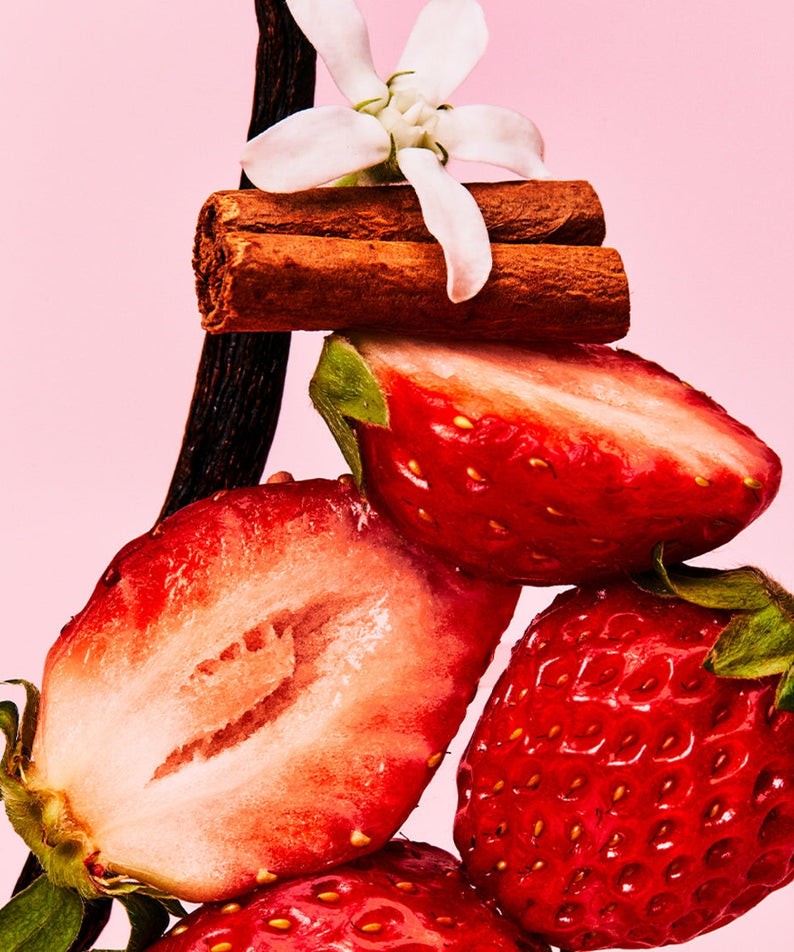 Fresh strawberries with vanilla pod, cinnamon sticks, and white flower on pink background representing OSULLOC Berry Vanilla Green Tea 20 P.