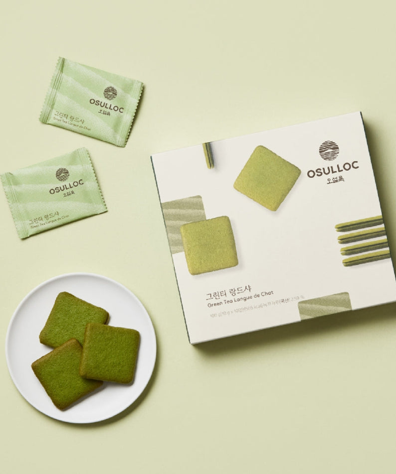 Box and plate of OSULLOC Green Tea Langue de chat 10 p. with individually wrapped cookies on a light green background.