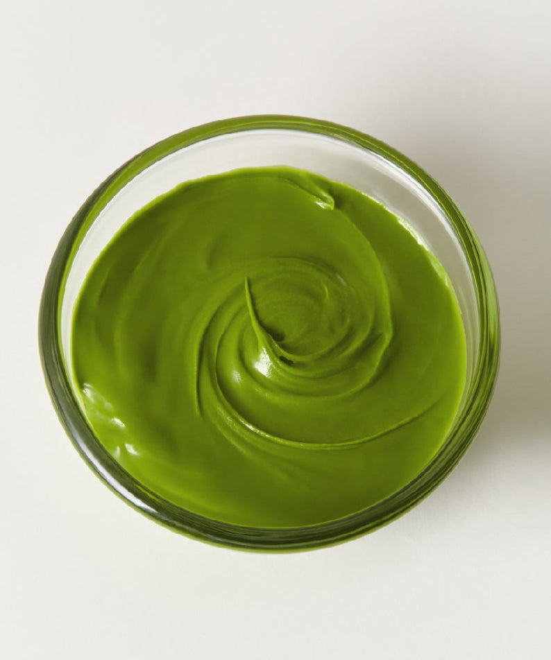 Glass bowl with OSULLOC Green Tea Milk Spread 200g, vibrant green color, creamy texture, ideal for diverse culinary applications.