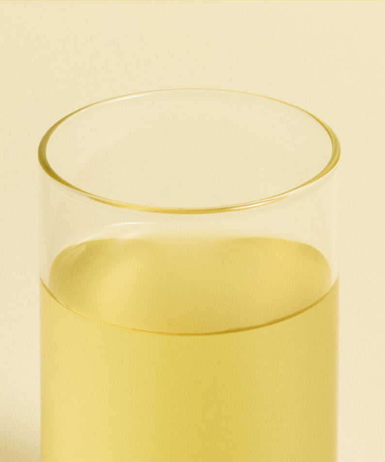 Glass of OSULLOC Canola & Apricot Tea 20 P on a neutral background