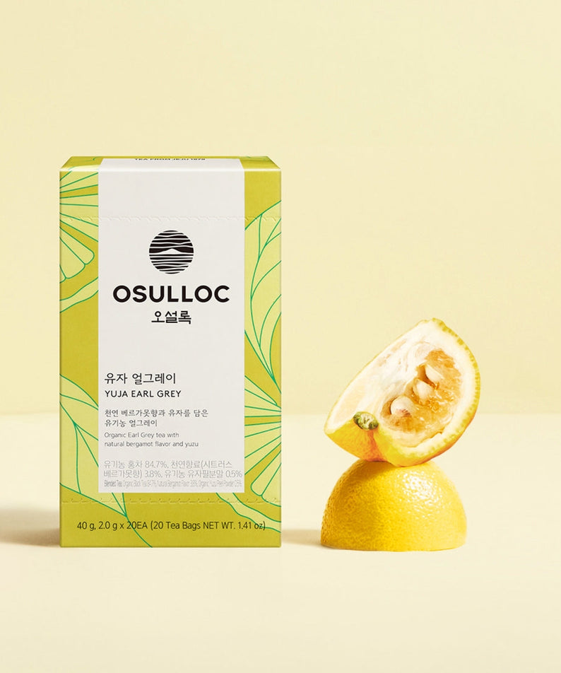 OSULLOC Yuja Earl Grey 20 p. tea box with fresh citrus on a light background