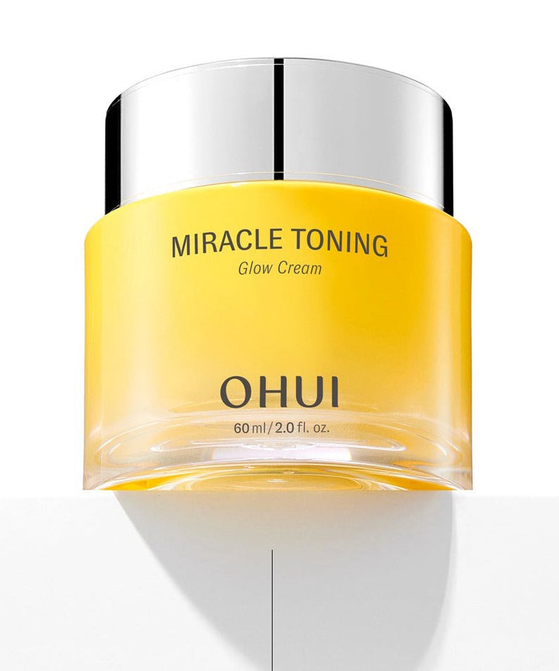OHUI Miracle Toning Glow Cream 60 mL in a sleek yellow jar with shiny silver lid