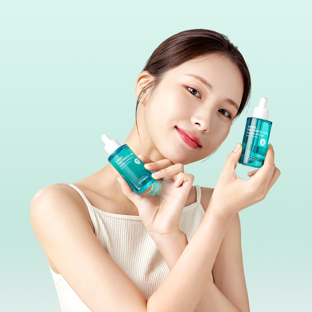 Woman holding PASSION&BEYOND Angel Tea Tree 10% Trouble Ampoule 50ml bottles smiling at camera