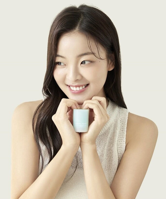 Woman holding PASSION&BEYOND Angel Aqua Moisture Plumping Lipcarin 15ml with a smile