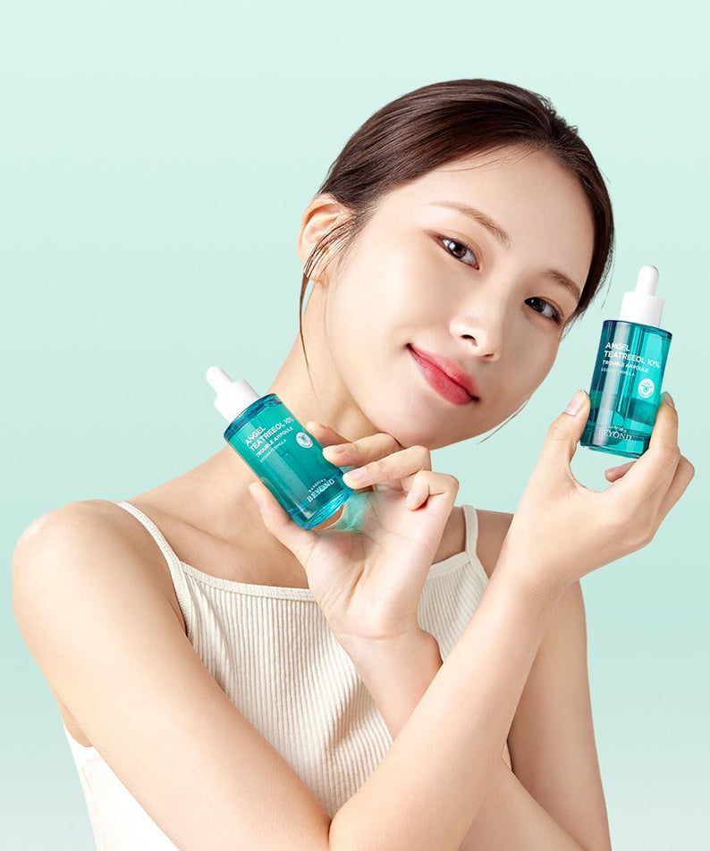 Woman holding PASSION&BEYOND Angel Tea Tree 10% Trouble Ampoule 50ml bottles smiling at camera