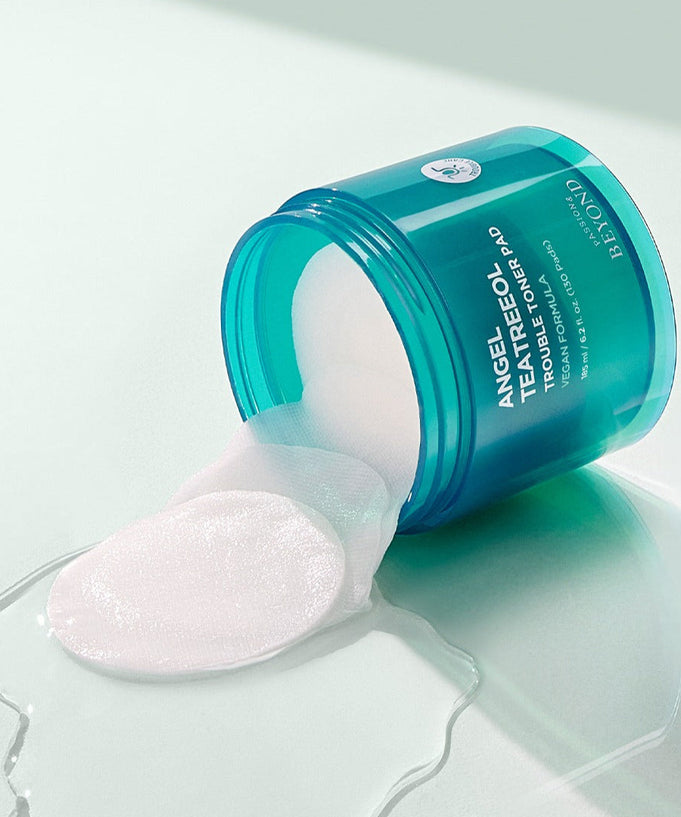 Open jar of PASSION&BEYOND Angel Tea Tree Trouble Toner Pads 185ml with spilling pads on a light surface