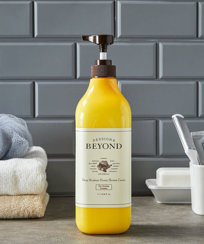 PASSON&BEYOND Deep Moisture Honey Shower 1L bottle on bathroom counter with towels and toothpaste