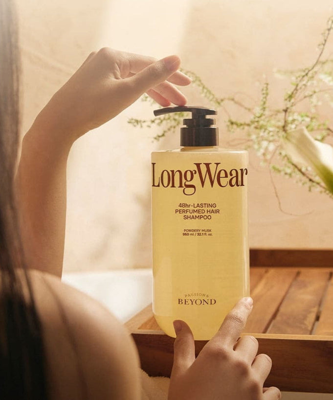 PASSON&BEYOND LongWear 48hr Lasting Perfumed Hair Shampoo 950ml bottle on wooden table with woman holding it in a serene setting