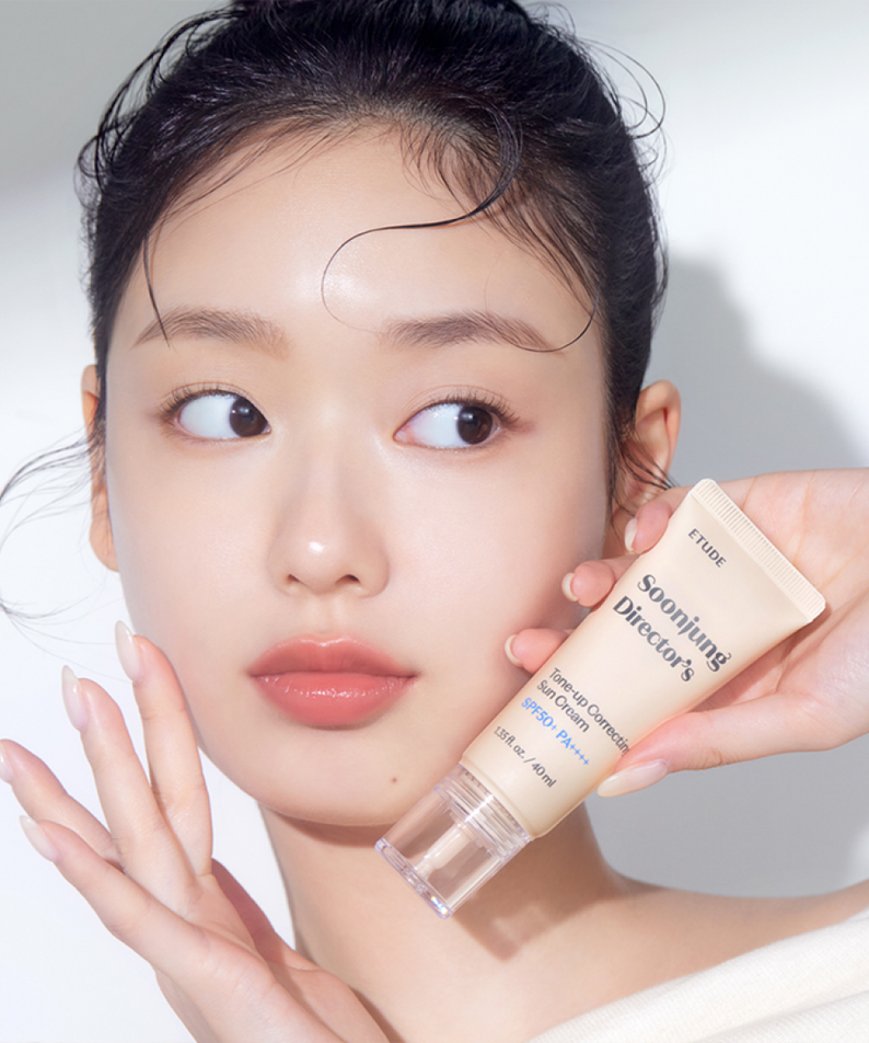 Woman holding ETUDE Pure Director Tone-Up Correction Sunscreen Planning Set SPF50+/PA++++ in her hand, showcasing product.