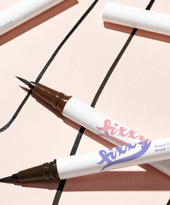 Close-up of PEACH C Brush Pixie Liner with intricate brush design on a light background.