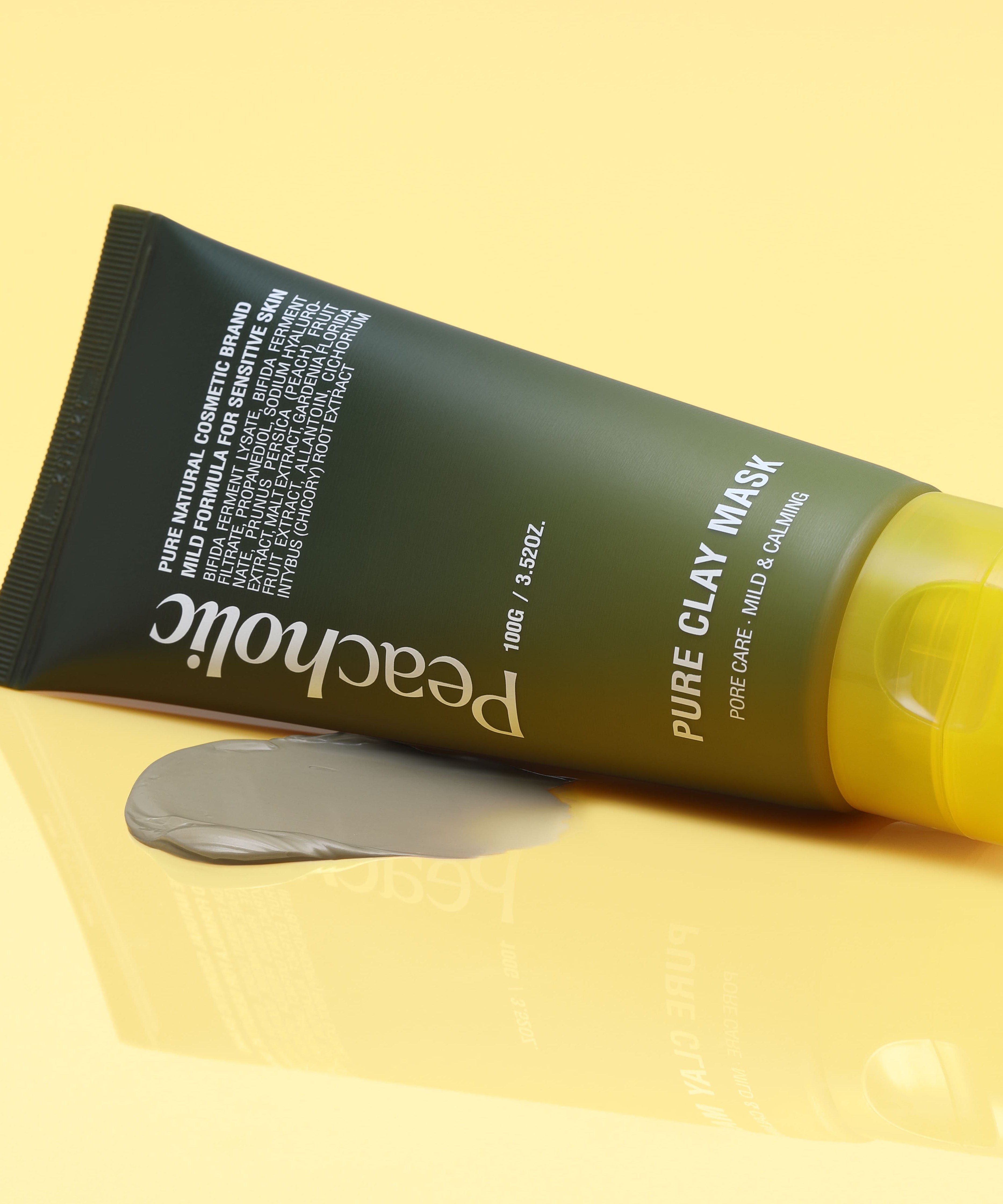 PEACHOLIC Pure Clay Mask 100ml tube with mask smear on yellow background.