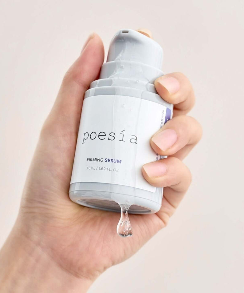 Hand holding POESÃA Hydro Phyto Collagen Deep Farming Ampoule Serum 48ml bottle with drop of serum.