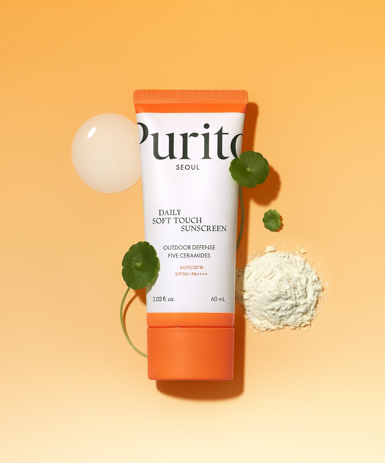 PURITO Daily Soft Touch Sun Cream SPF50+PA++++ with botanical elements on an orange background.