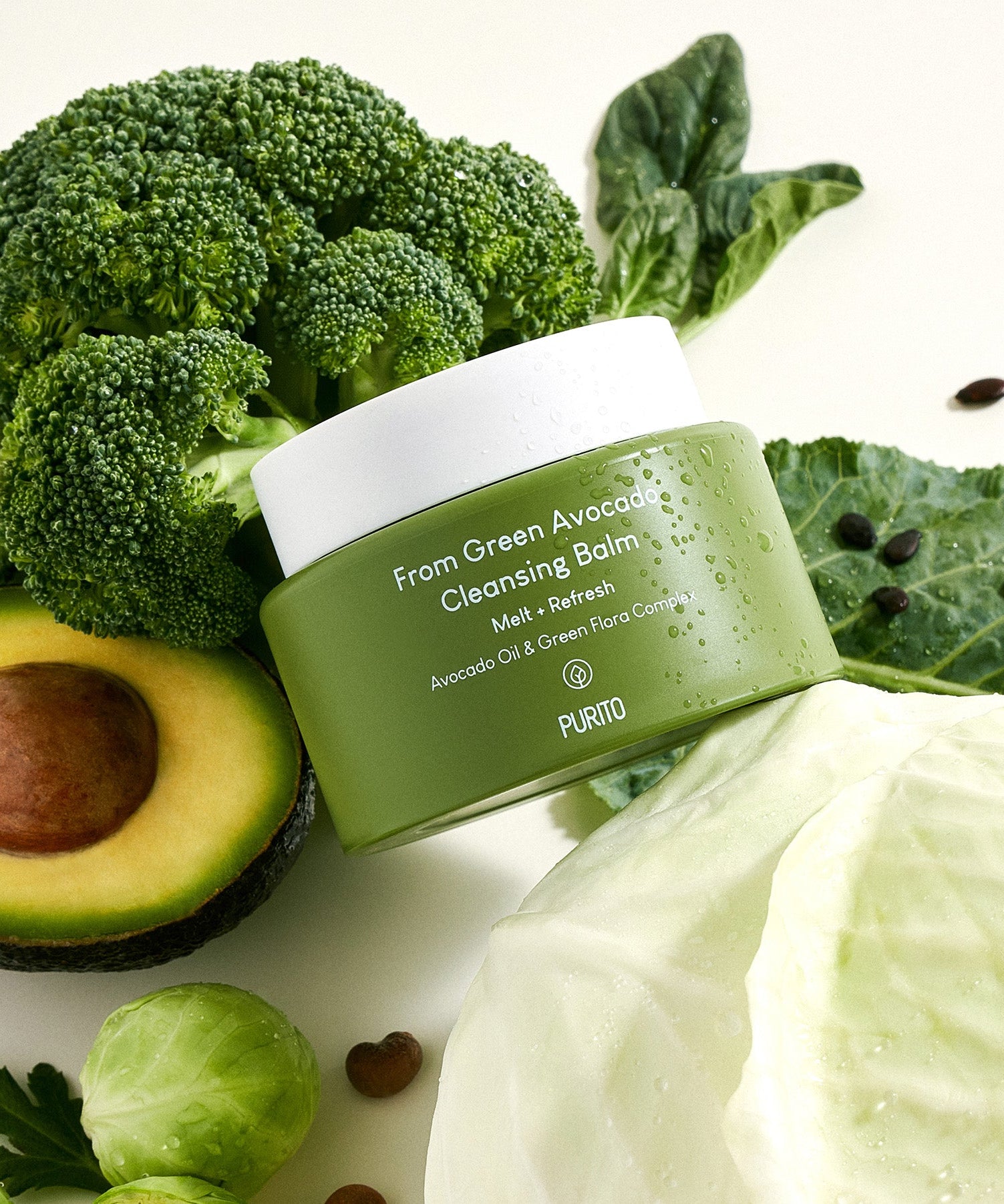 PURITO From Green Avocado Cleansing Balm 100ml surrounded by fresh avocado, broccoli, and cabbage, showcasing natural ingredients.