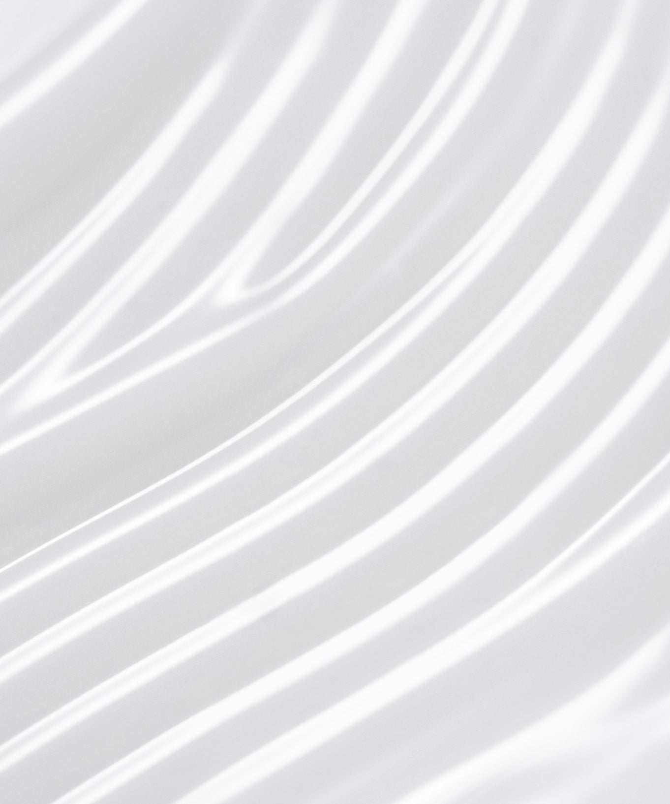 Close-up of smooth, white flowing fabric texture, showcasing intricate waves and patterns.