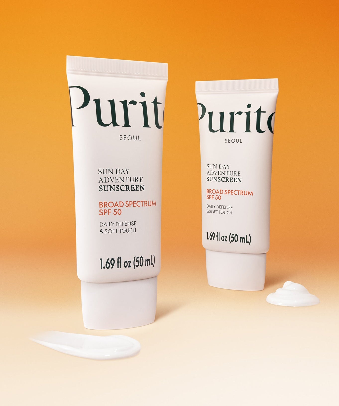 PURITO Sunday Adventure Sunscreen SPF50 50ml tubes on an orange background