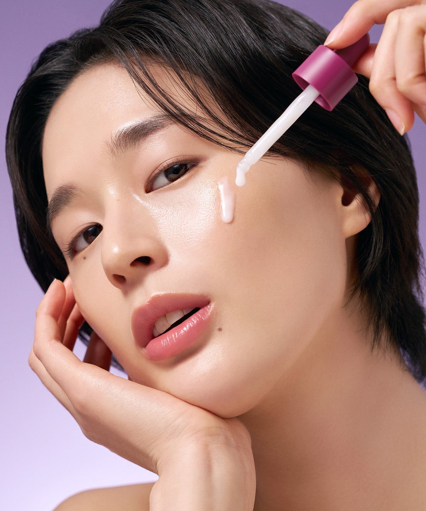 Model applying PURITO Timeless Bloom Bakuchiol Serum 30ml on face with dropper