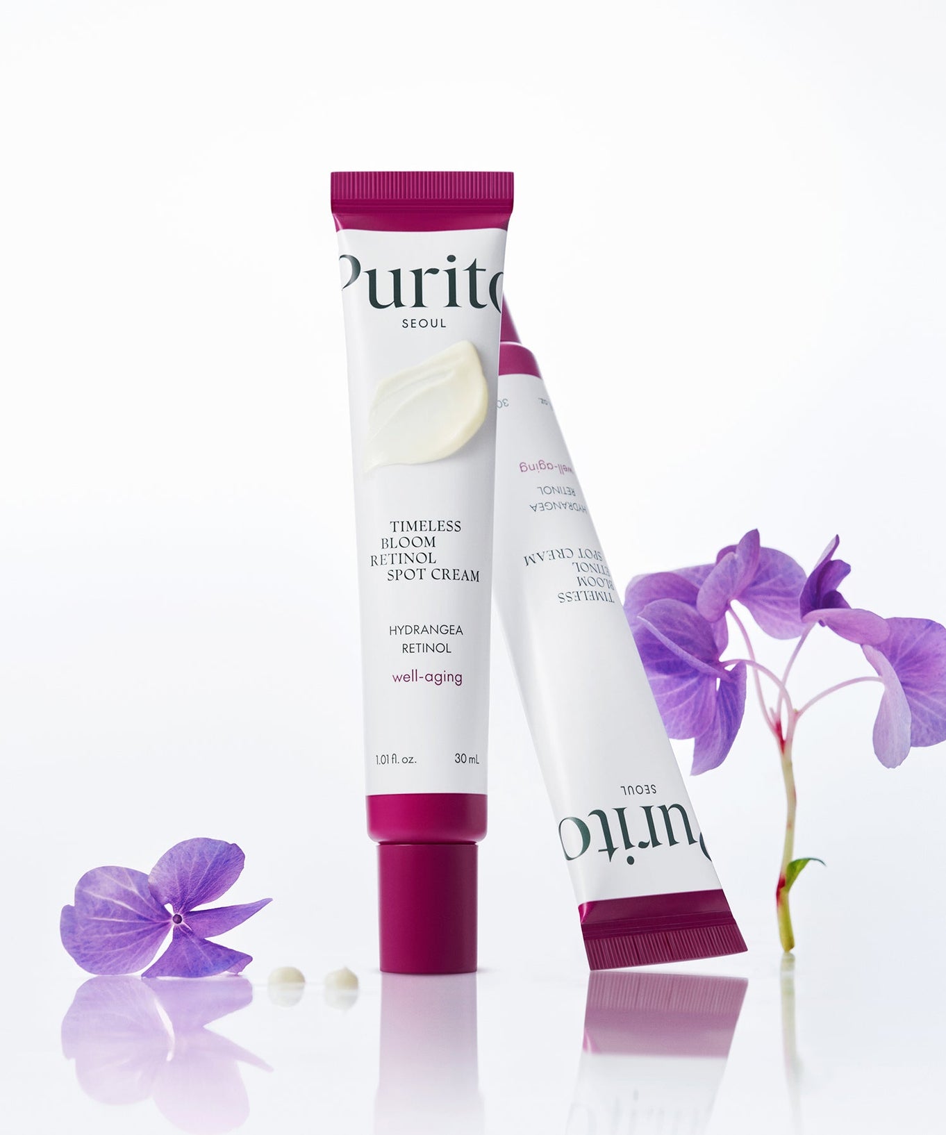 PURITO Timeless Bloom Retinol Spot Cream 30ml tube with purple flowers displayed elegantly.