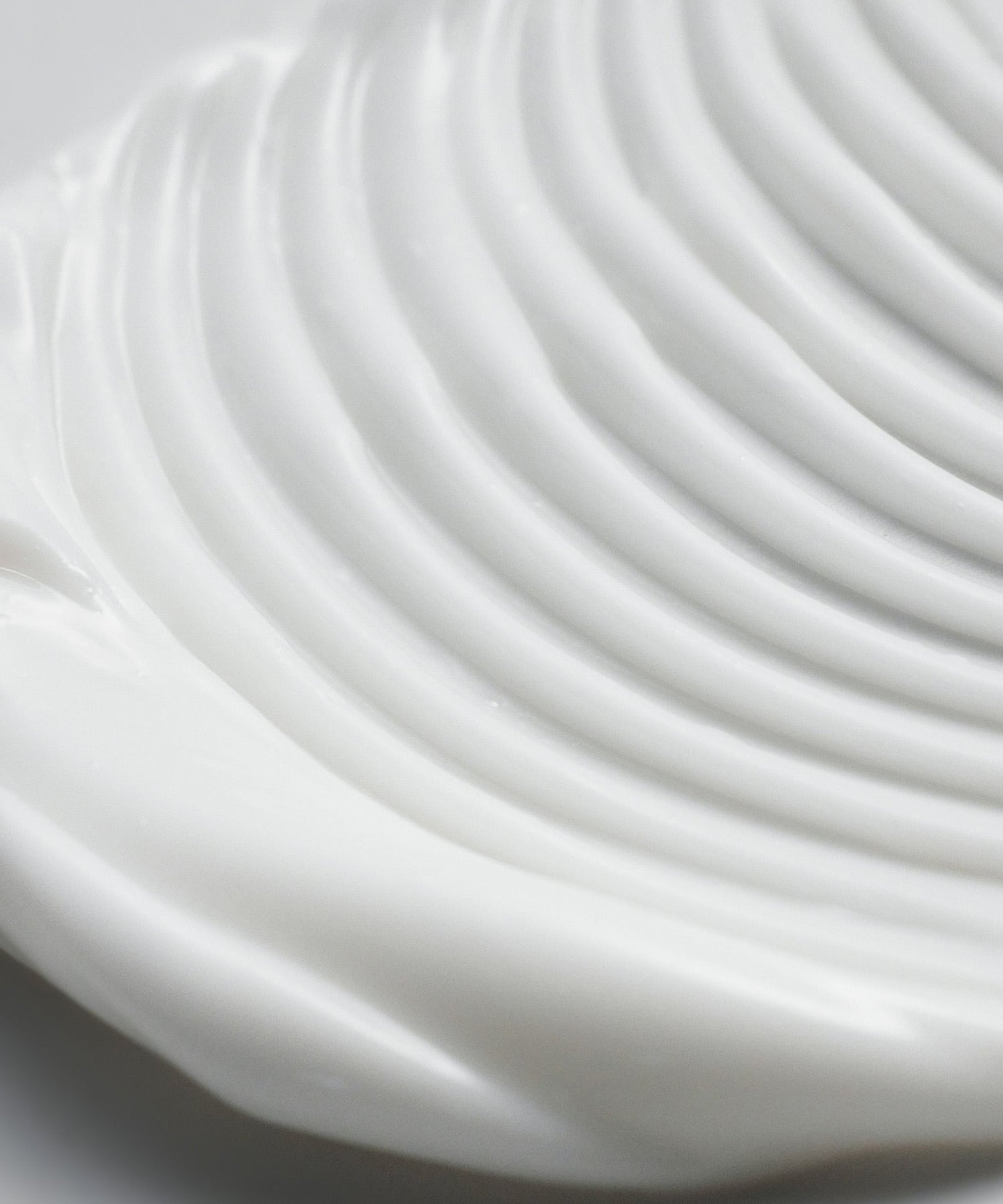 Close-up texture of PURITO Wonder Relief Centella Cream Unscented 50ml, showcasing creamy consistency on a smooth surface.