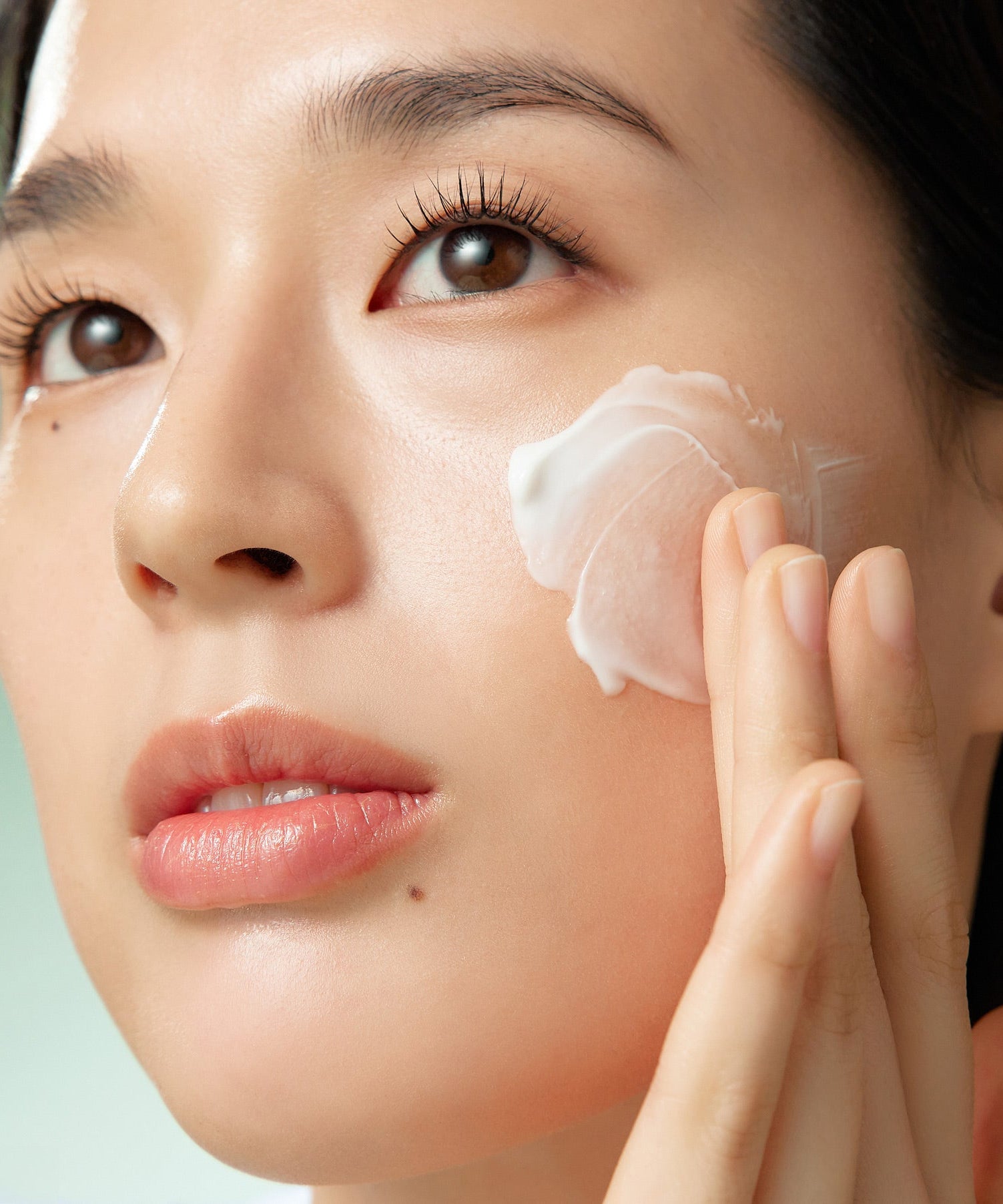 Applying PURITO Wonder Relief Centella Cream Unscented 50ml on face for skincare routine