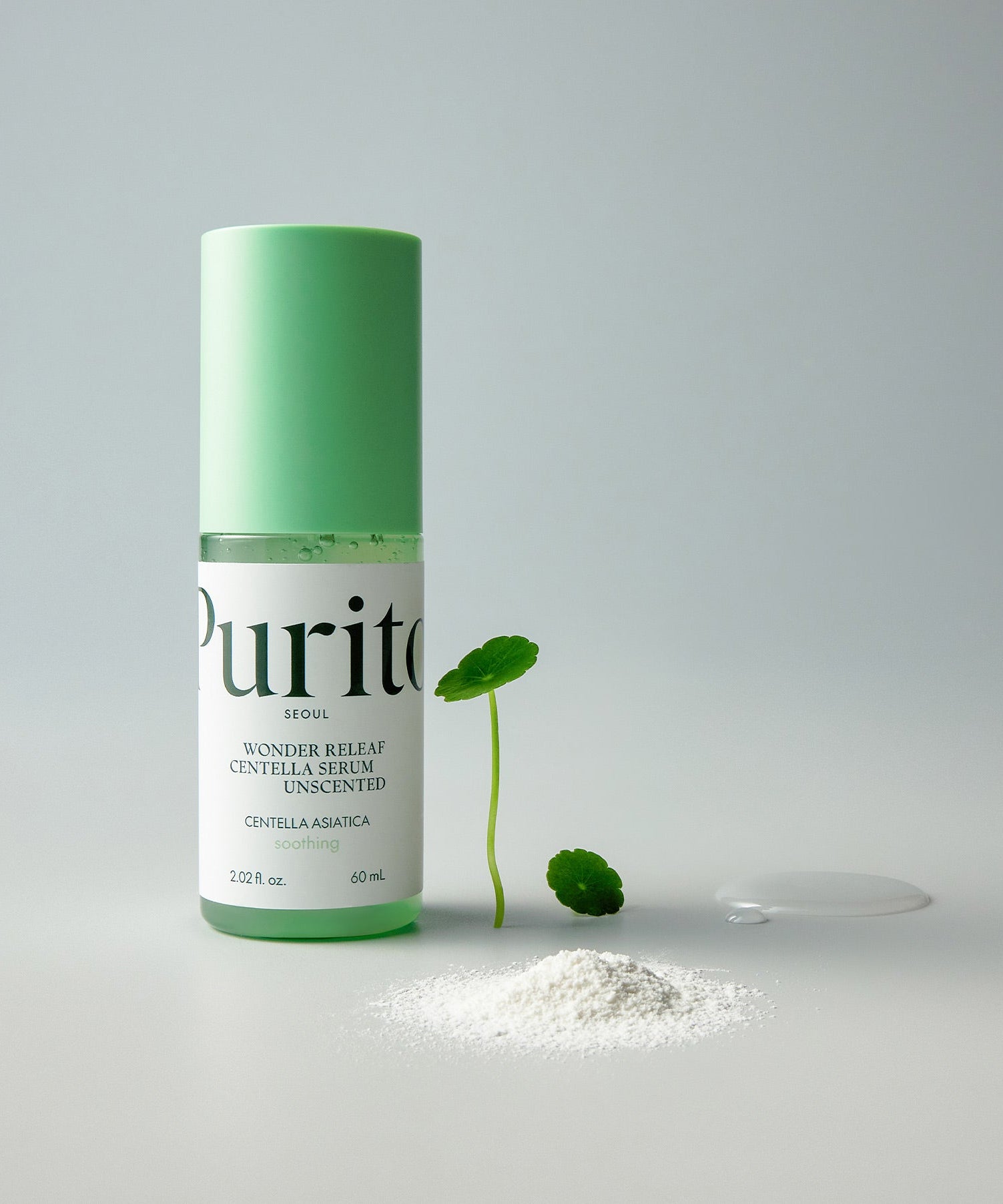 PURITO Wonder Relief Centella Serum Unscented 60ml bottle with green cap, next to centella asiatica leaf and powder.