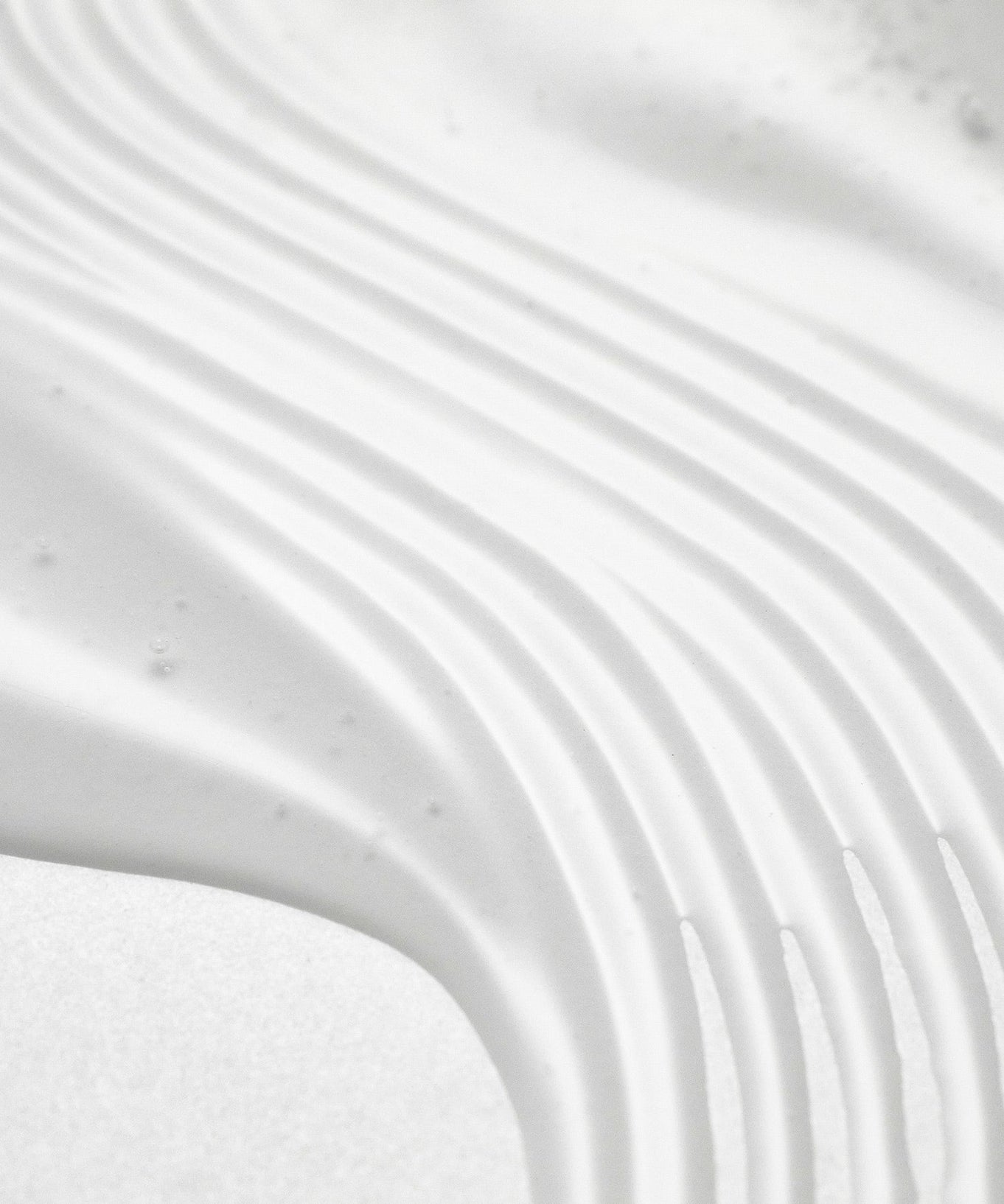 Texture pattern of PURITO Wonder Relief Centella Serum Unscented 60ml with smooth, even application lines. Enhance skincare routine.