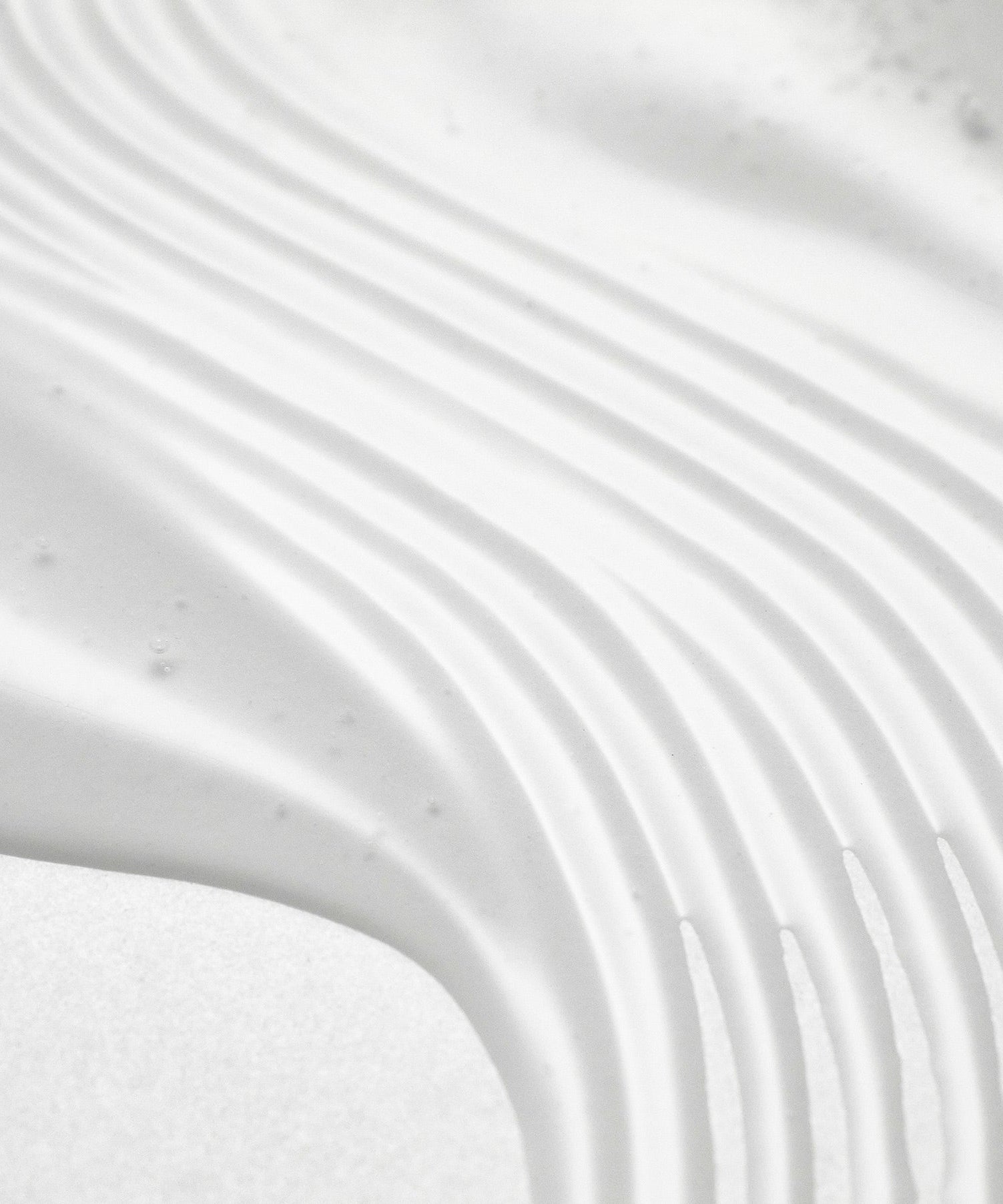 Texture pattern of PURITO Wonder Relief Centella Serum Unscented 60ml with smooth, even application lines. Enhance skincare routine.