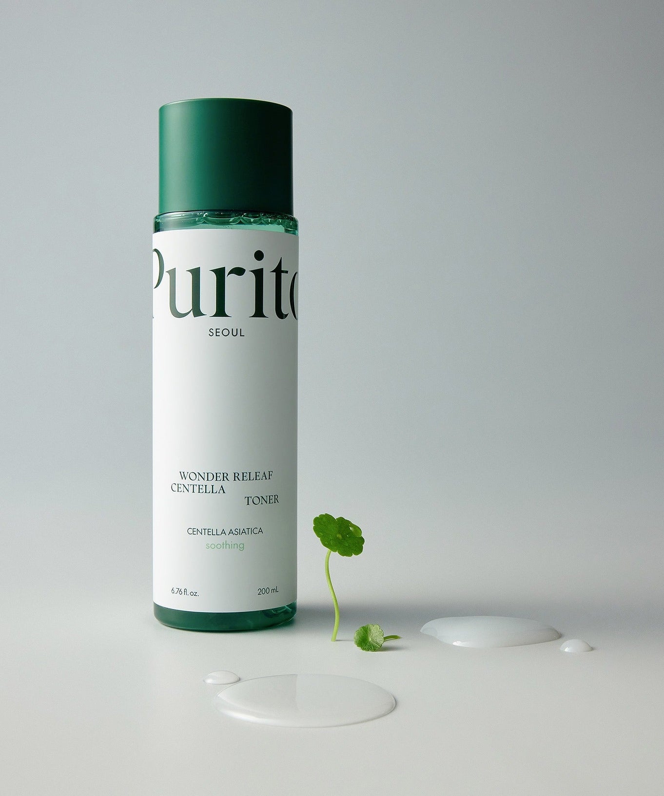 Bottle of PURITO Wonder Relief Centella Toner 200ml with plant and liquid on white background.