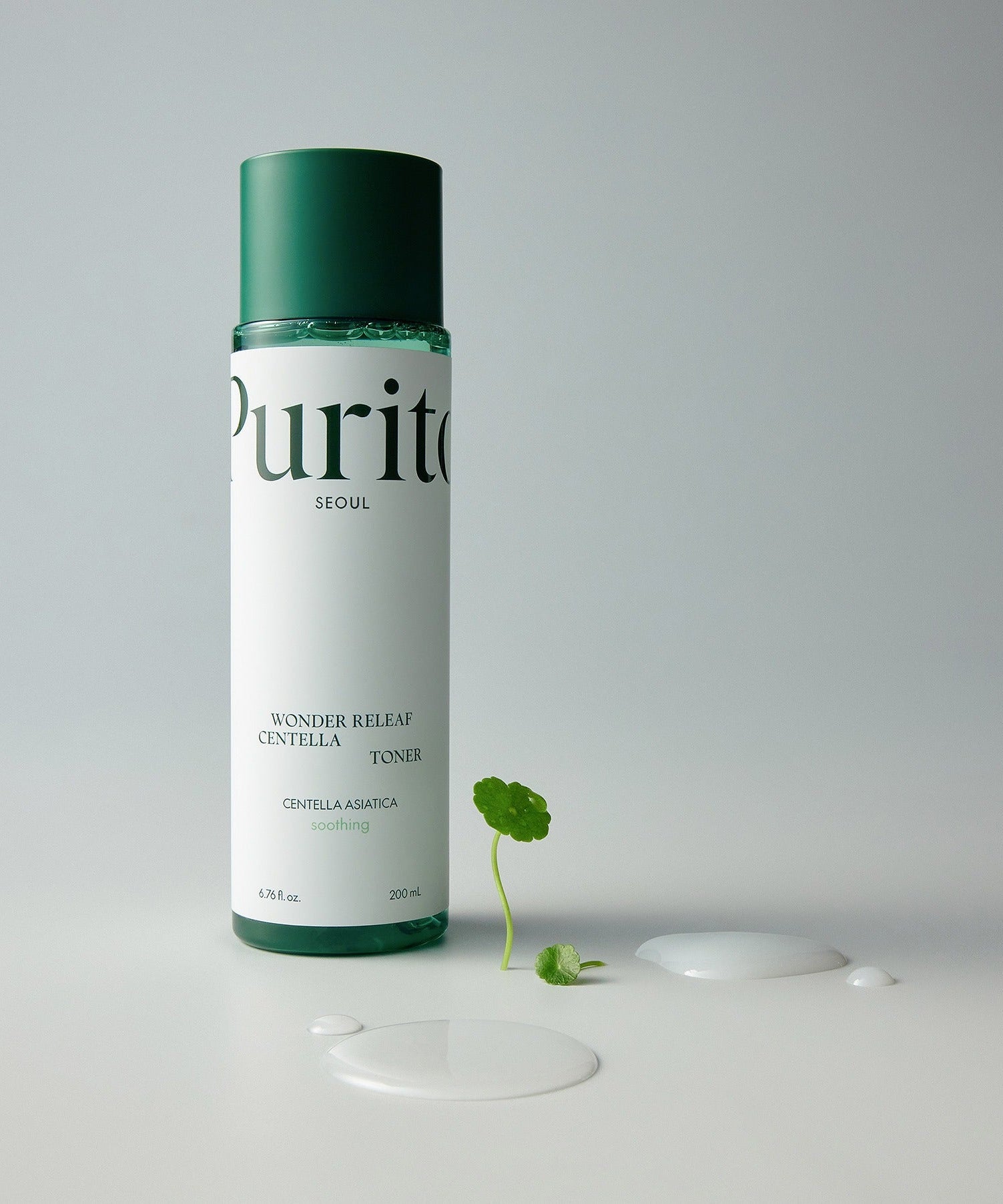 Bottle of PURITO Wonder Relief Centella Toner 200ml with plant and liquid on white background.