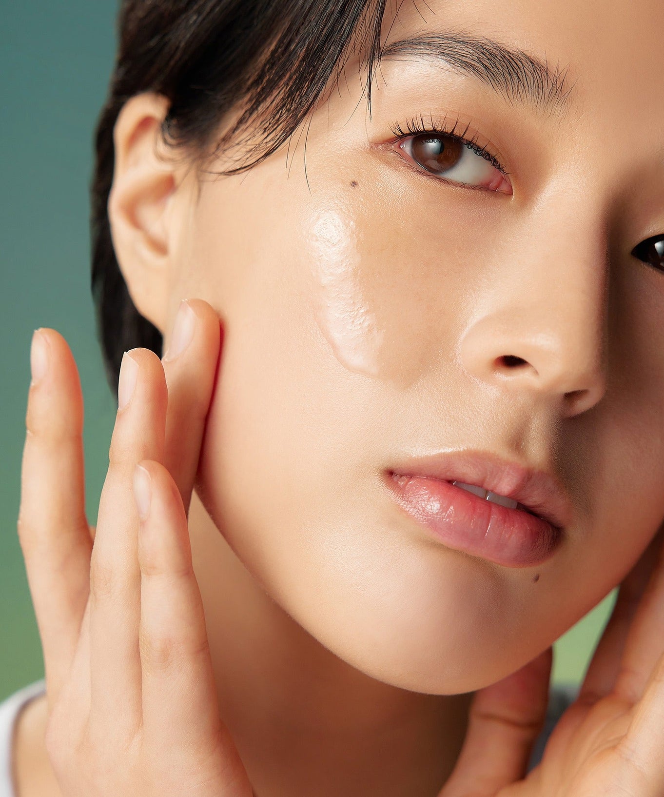 Close-up of a person applying PURITO Wonder Relief Centella Toner 200ml to their face
