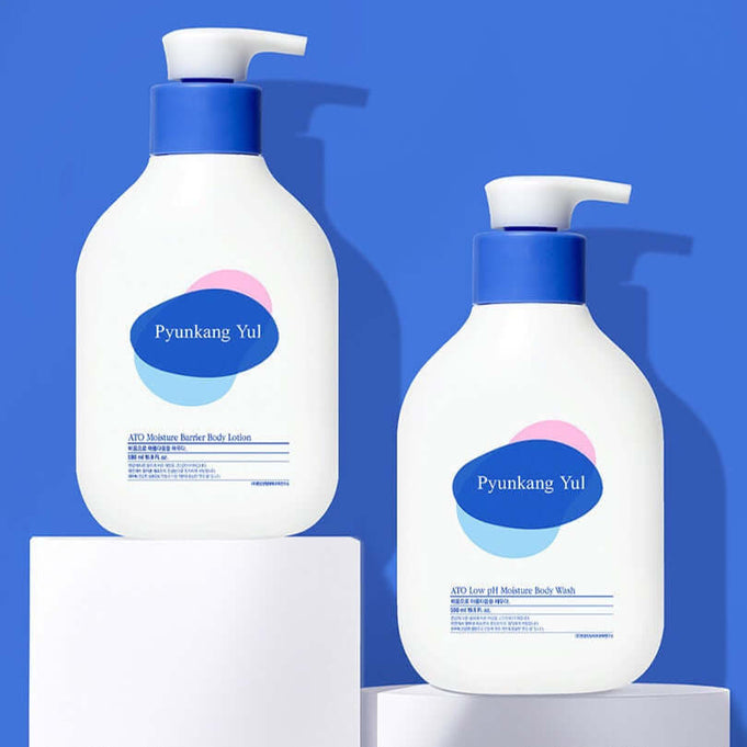 PYUNKANG YUL Ato Moisturizing Barrier Body Lotion 590ml and Moisture Body Wash bottles on a blue background