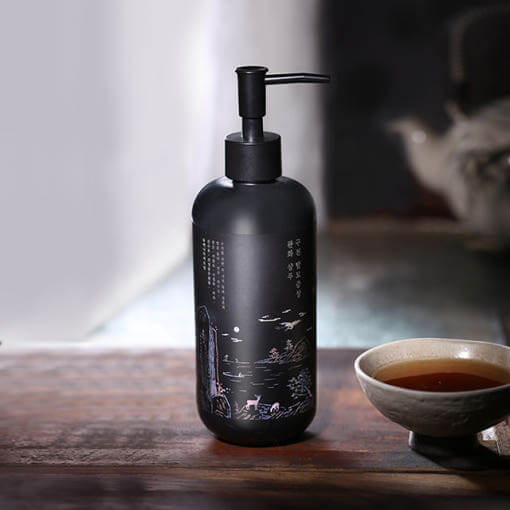 PYUNKANG YUL Black Tea Oral Hair Loos Relief Shampoo 500ml bottle next to a cup of tea on a wooden surface, elegant packaging