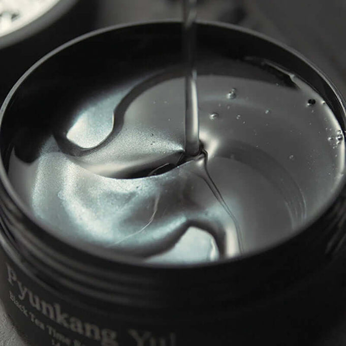 PYUNKANG YUL Black Tea Time Reverse Eye Patch 60 Sheets in open container showcasing glossy texture, perfect for rejuvenating eyes.
