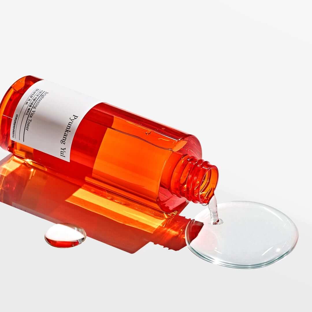 PYUNKANG YUL Brightening Vita Toner 150ml bottle pouring liquid on white surface