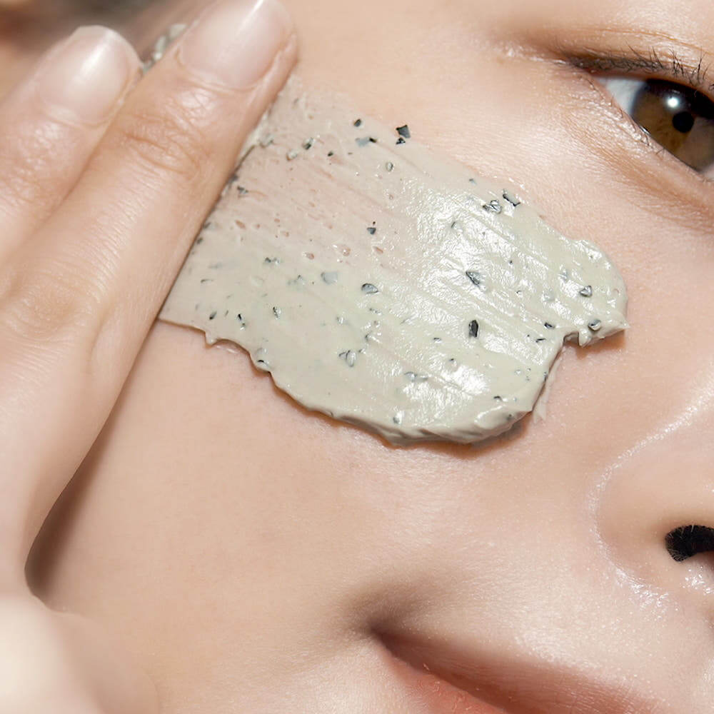 Close-up of PYUNKANG YUL Calming Pore Clear Wash Off Pack 100ml being applied on skin.